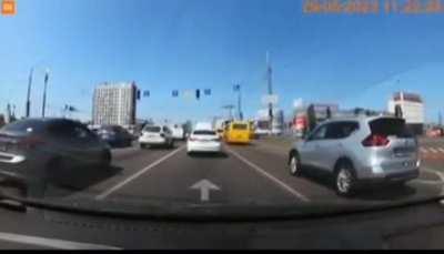 Dashcam footage of a ballistic missile or AA missile fragments falling off on a lively road in Kyiv