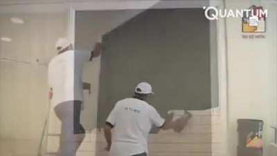 The way this worker makes a brick effect on the wall - it's just amazing!