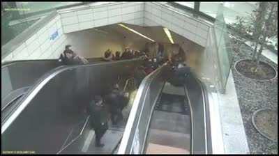 Watch a man survive getting swallowed by an escalator