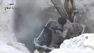 Soldier lowered into a tunnel in a excavator to clear ISIS militants.