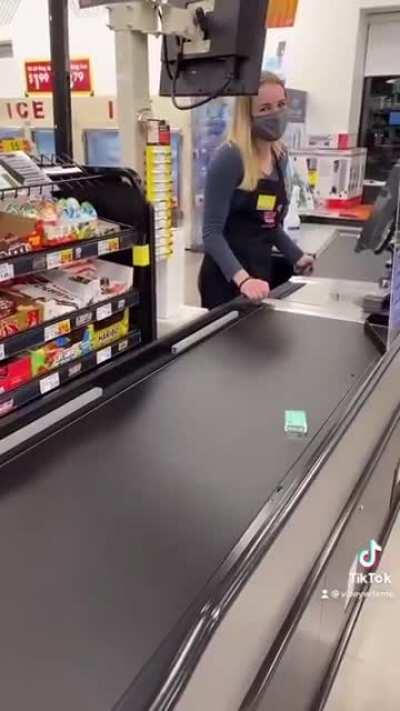 Cashier waiting on Tictacs to go all the way down the belt