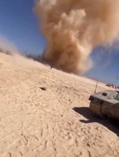 Soldier running into a dust devil