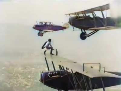 An extremely brave woman jumps from plane to plane to mid-air to change a landing gear. 1926.