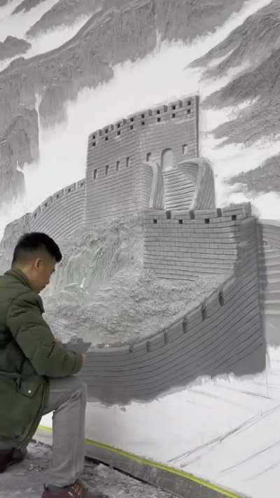 This guy using plaster to create a 3D painting of the Great Wall.