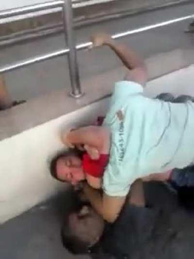 Guys fight on top of a homeless dude