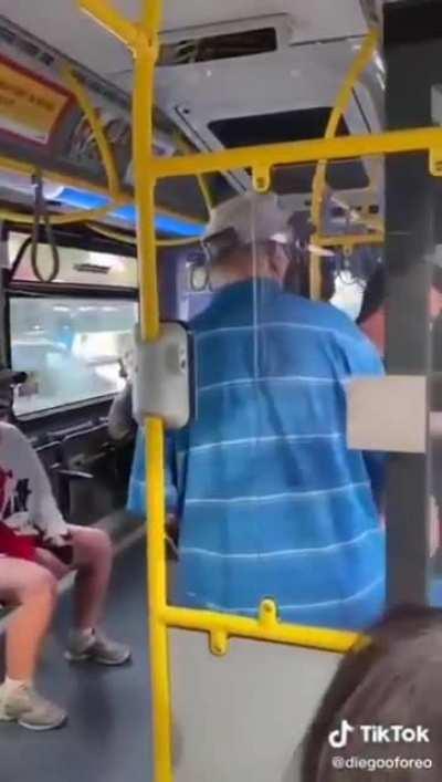 Women spits on man on the bus.