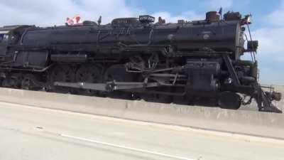 Steam powered locomotive (Santa Fe 3751) smokin it down a California highway