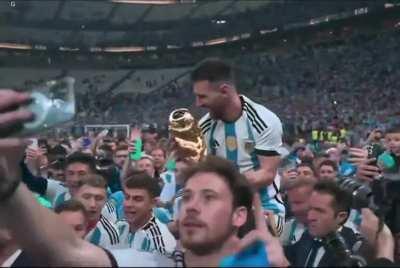 Lionel Messi being carried on Sergio Aguero's shoulders whilst lifting the World Cup trophy