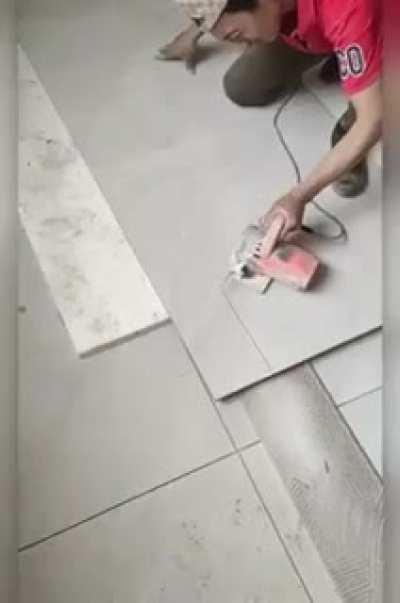 this tile worker doing his job