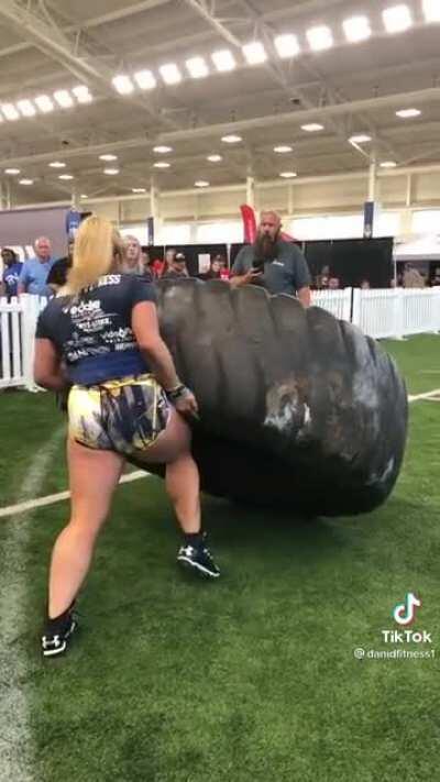 Strongwoman lifts a 500lb tire