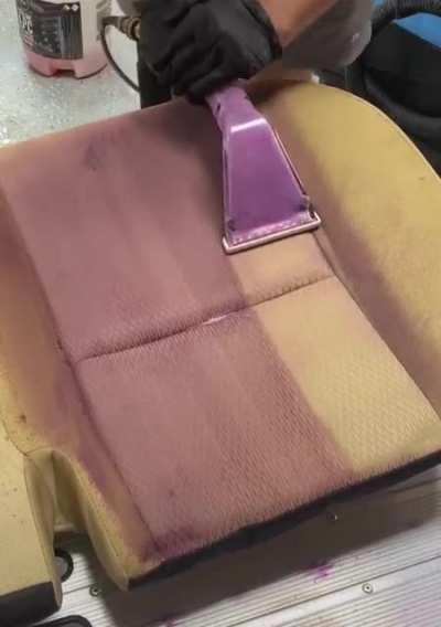 Deep cleaning a stained car seat.