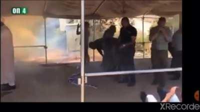 Israel police throwing flash and tear gas when muslim Palestinian doing prayer