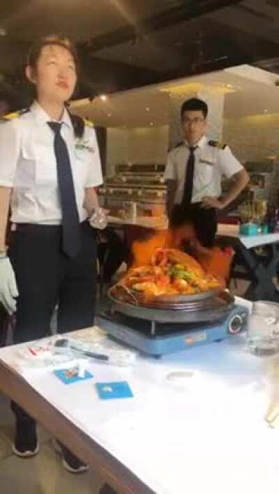 Cooking the food by lighting it on fire with the help of a special technique