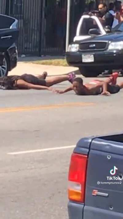 Woman is forced to lie on burning hot cement at gun point