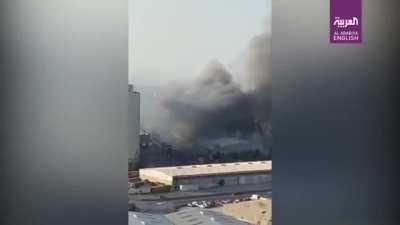 Couple on balcony filming the explosion