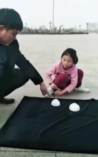 Eggstremely good 'cups and balls' trick by this young girl