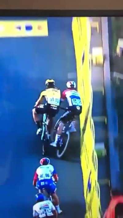 Biker Pushes competitor off then then debris knocks them off too