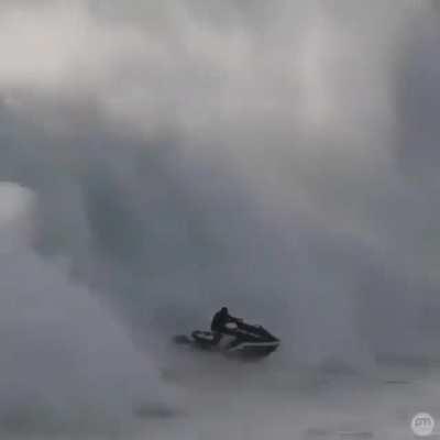 A man saves another from a giant wave