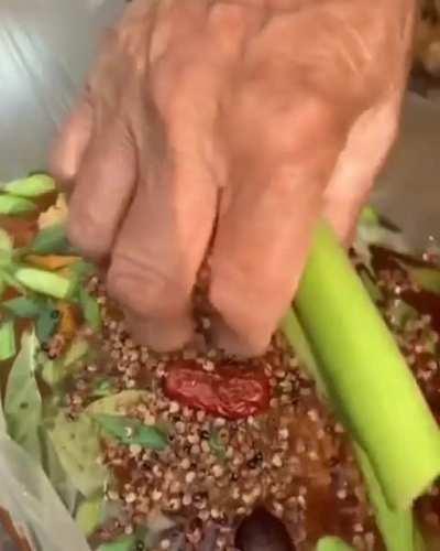 Making a fish stew in a plastic bag over a fire. The plastic bag doesn't melt when it has water inside because the applied heat is transferred to the water instead of being absorbed by the plastic.