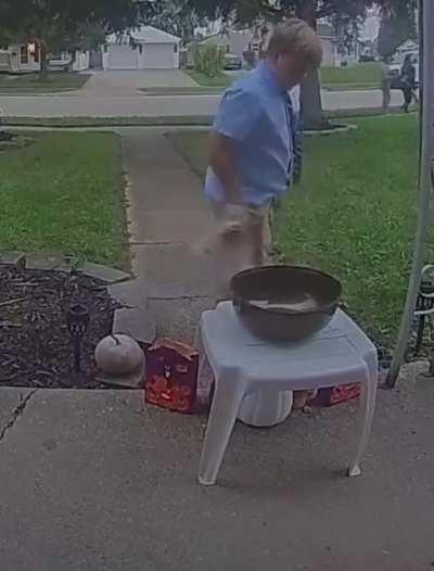 This kid saw the bowl was empty so he shared his candy with the next trick or treaters.