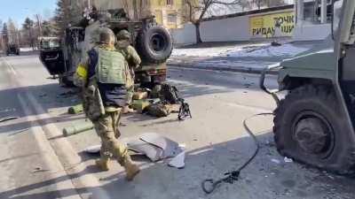 Destroyed Russian light vehicle section being looted by Ukrainian forces