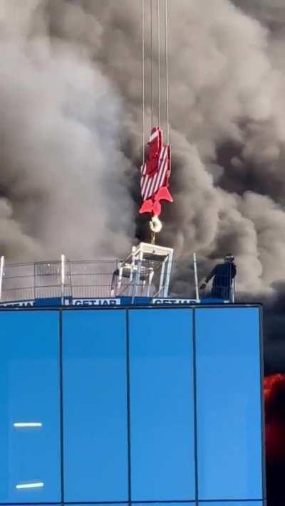 Crane operator saves person from fire.