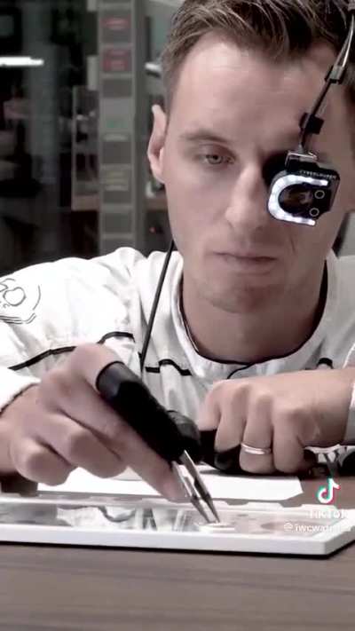 A man demonstrates how a Swiss watch is made.