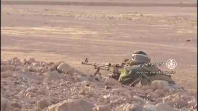 Prone Syrian Arab Army soldier nearly dies after receiving accurate fire from opposition forces.