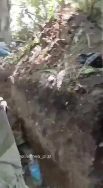 Ukraine soldiers in a trench take a Russian prisoner