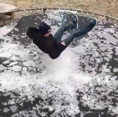 Breaking ice on a trampoline