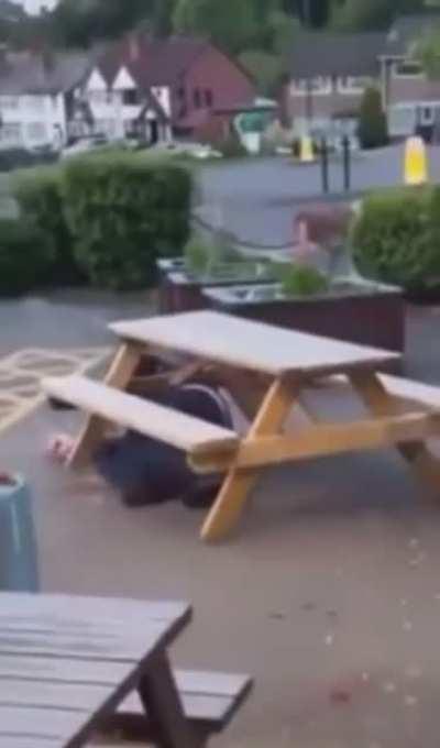 Angry drunk guy tries to flip a table.