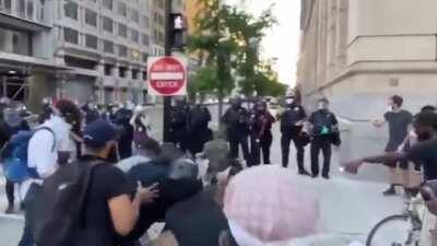 Peaceful protesters in DC prevent a man from damaging property and hand him over to the police