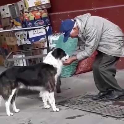 Old man helping out good boy with some water.