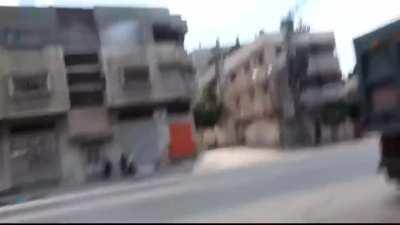 Palestinian civilians carrying an injured person out of an active war zone to the red crescent during the 2014 battle of shujaiyya