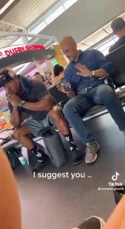 Bro gets upset when someone sits next to him at the airport terminal.