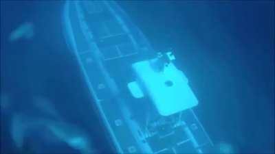 Submarine passes under diver