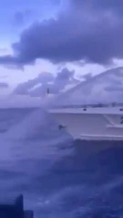 A Philippine Coast Guard boat with General Romeo Brawner Jr. , Chief of Staff of the Armed Forces of the Philippines on board flees as a Chinese Coast Guard ship fires water cannons towards another Philippine boat a day after using water cannons against c