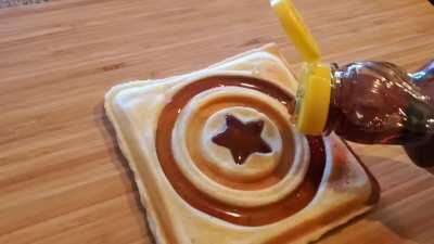 Adding syrup to Super Hero waffles for my kids