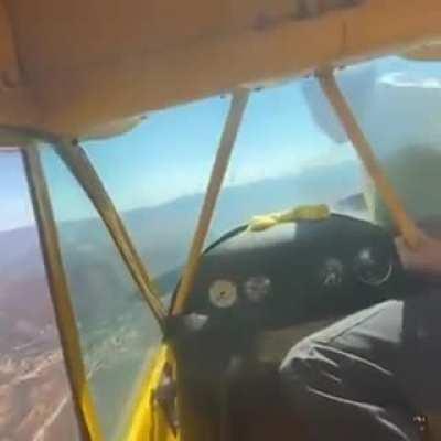 Hand starting a plane mid air