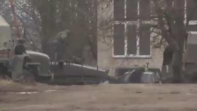 Russian soldiers running for cover after artillery blasts heard in background