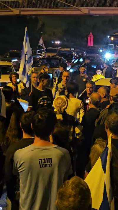 Israelis block highway protesting against corrupt govt. Netanyahu supporter who's car is blocked gets out to fight them. 