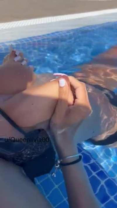 Playing with my tits in the pool