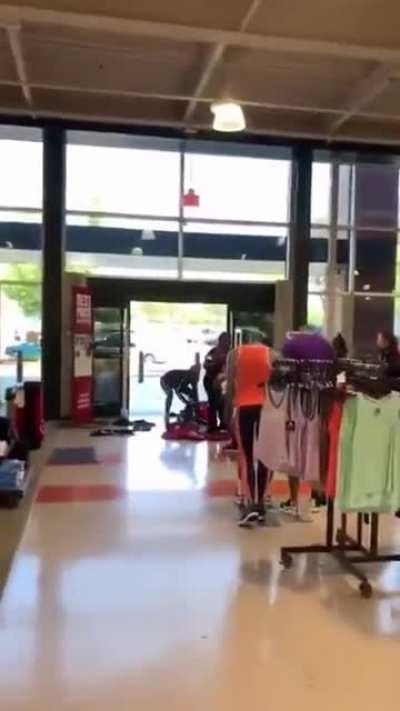 Group of ladies looting store for clothes fight security as they make their grand escape.