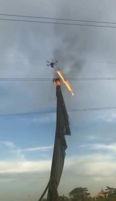 A flamethrower drone used to clear debris from power lines