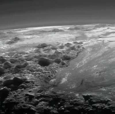 Wow, this is from freaking Pluto. Pluto’s ice mountains, frozen plains and layers of atmospheric haze backlit by a distant sun, as seen by the New Horizons spacecraft.