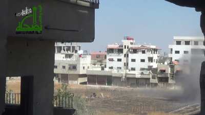 Al-Miqdad Brigade camera set up to observe a Syrian Army T-72 laying rounds into recently stormed block of buildings - 2013