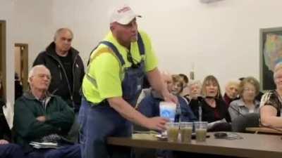 A farmer in Nebreska asking a pro-fracking committee member to honor his word by drinking water from a fracking location.