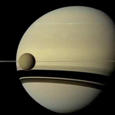 Timelapse of Europa and Io orbiting Jupiter captured by the Cassini probe