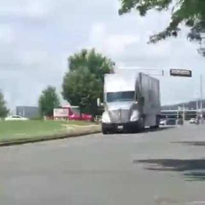 Swift truck driver takes out a traffic light.
