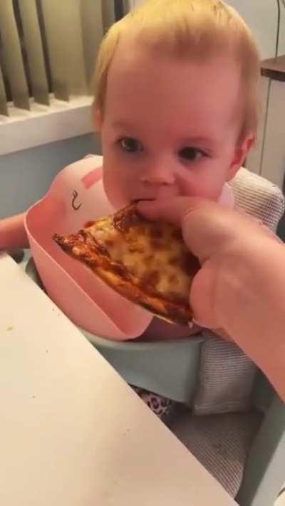 baby's first bite of pizza